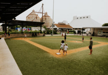 kids playing on baseball field