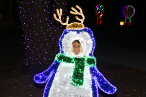penguin made of christmas lights with child's face
